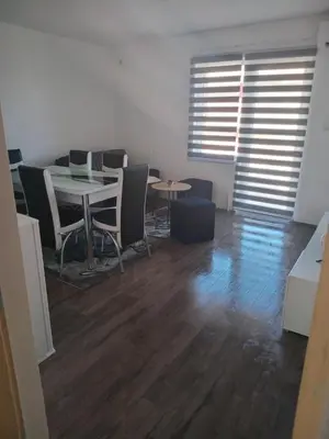 a room with a table and chairs and a table and a table and chairs at Apartmani SARA Vranje in Vranje