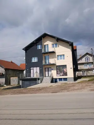 a large house is shown on the side of a street at Apartmani SARA Vranje in Vranje