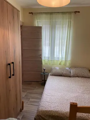 a bedroom with a bed and a window at Apartman Vuk, Crni Vrh - Stara planina in Crni Vrh