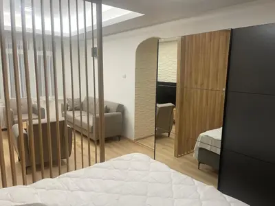 a bedroom with a bed and a mirror at Apartman Dasha in Brzeće