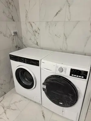 a white washer and dryer sitting in a bathroom at Apartman Dasha in Brzeće