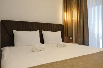 a bed with three rolled towels on top of it at Mountain Paradise Ski In & Out - Vila Golija Kopaonik in Kopaonik