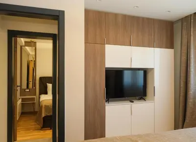 a bedroom with a flat screen tv in a room at Mountain Paradise Ski In & Out - Vila Golija Kopaonik in Kopaonik