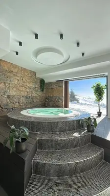 a swimming pool with a jacuzzi in a house at Mountain Paradise Ski In & Out - Vila Golija Kopaonik in Kopaonik