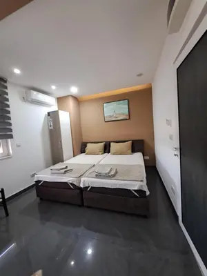 a bedroom with a large bed in a room at Lena lux in Jagodina