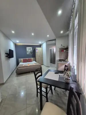 a living room with a bed and a table at Lena lux in Jagodina