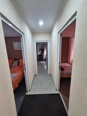 a hallway of a hotel room with two beds at Lena lux in Jagodina