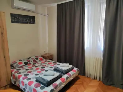 a bedroom with a bed with polka dots on it at Donin apartman in Niš