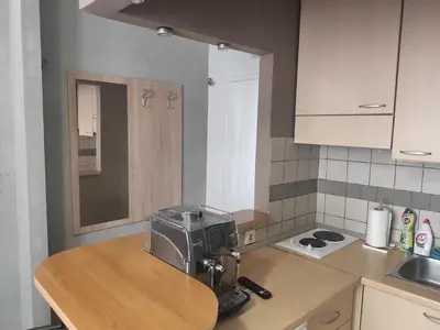 a kitchen with a coffee maker on a table at Donin apartman in Niš