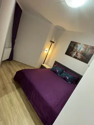 a bedroom with a purple bed in a attic at Jokica apartmani in Paraćin