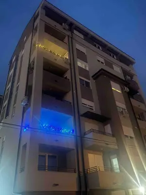 a building with blue lights on the side of it at Jokica apartmani in Paraćin