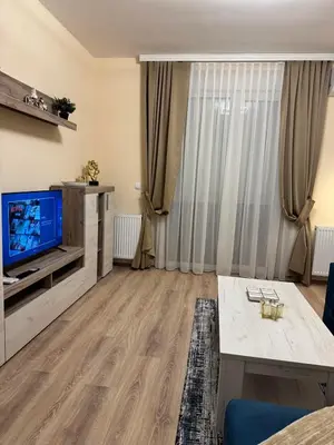a living room with a television and a couch at Jokica apartmani in Paraćin