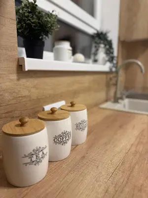 three cups sitting on a counter in a kitchen at Jokica apartmani in Paraćin