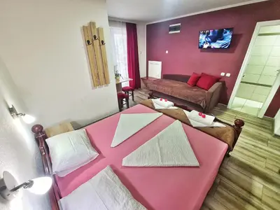 a living room with a pink table and a couch at Vila Aleksandra 2 Studio 3 in Soko Banja