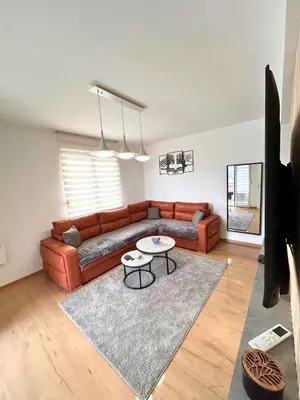 a living room with a couch and a table at Happiness Apartman in Vrnjci