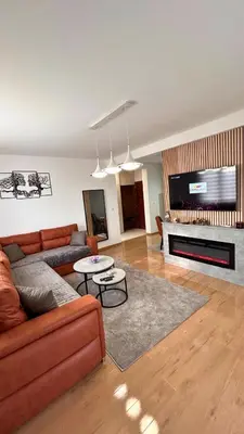 a living room with a couch and a flat screen tv at Happiness Apartman in Vrnjci