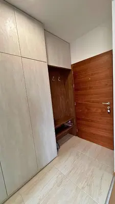 a room with two sliding doors and a wooden door at Happiness Apartman in Vrnjci