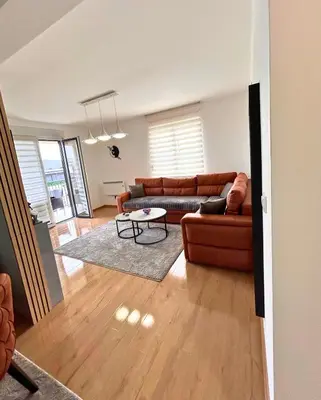 a living room with a couch and a table at Happiness Apartman in Vrnjci