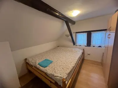 a small bedroom with a bed in a room at Centar kop in Kopaonik