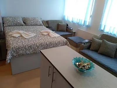 a room with a bed and a couch and a table at Smeštaj Vesna in Soko Banja