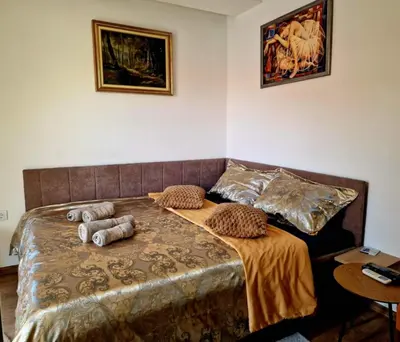 a bed with pillows on it in a room at Apartman Vesna in Leskovac