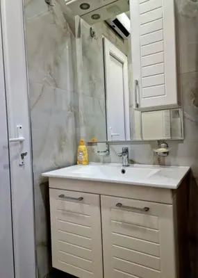 a bathroom with a white sink and a mirror at Apartman Vesna in Leskovac