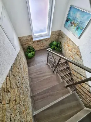 a staircase with a stone wall and a window at Vila Aleksandra 2 Studio 8 in Soko Banja