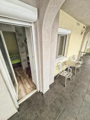 a balcony with a table and chairs in a building at Vila Aleksandra 2 Studio 8 in Soko Banja