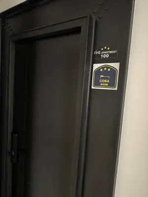 a black elevator door with a sign on it at Fine apartments Nis in Niš