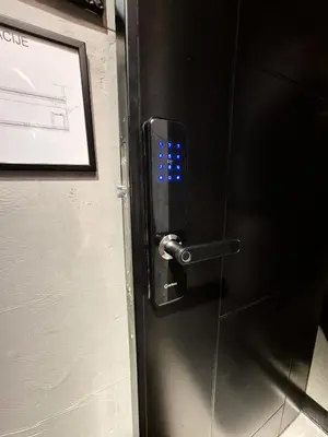 a elevator door with a blue light on it at Fine apartments Nis in Niš
