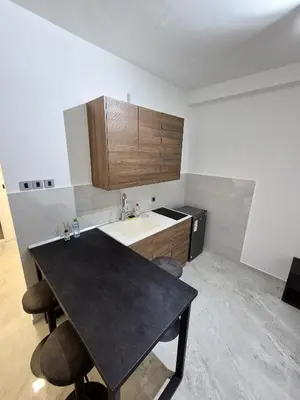 a kitchen with a black table and a sink at Fine apartments Nis in Niš