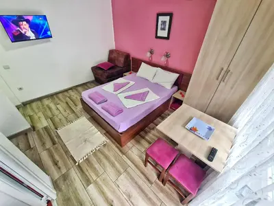 a small room with a bed and a chair at Vila Aleksandra 2 Studio 11 in Soko Banja