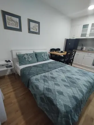 a bedroom with a bed and a table in it at Sofika in Vrnjačka Banja