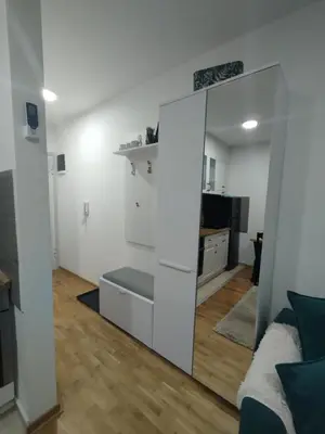 a living room with a large white cabinet in a room at Sofika in Vrnjačka Banja