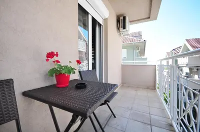 a balcony with a table with a plant on it at Apartman Cvetkovic in Vrnjačka Banja