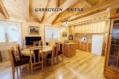 a kitchen and dining room with a table and chairs at Gabrielin kutak in Mužinac