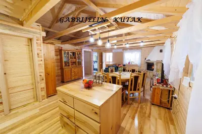 a kitchen and dining room with wooden floors and ceilings at Gabrielin kutak in Mužinac