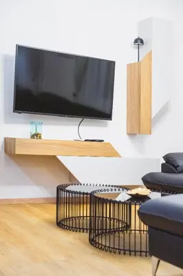 a living room with a flat screen tv on a shelf at Luka's apartment in Pirot