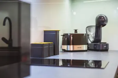 a counter top with a toaster and a coffee maker at Luka's apartment in Pirot