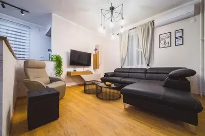 a living room with a couch and a tv at Luka's apartment in Pirot