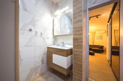 a bathroom with a sink and a mirror at Luka's apartment in Pirot