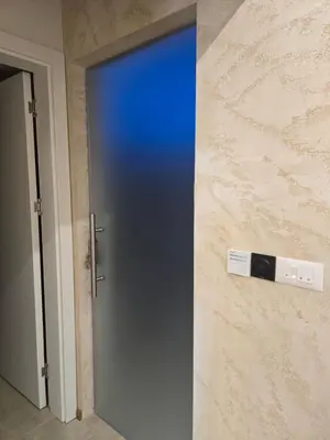 a blue door in a room with a wall at In lux spa apartman 2 in Vrnjačka Banja