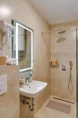 a bathroom with a sink and a shower at In lux spa apartman 2 in Vrnjačka Banja
