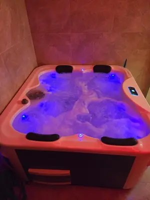 a jacuzzi tub with purple dye in a bathroom at In lux spa apartman 2 in Vrnjačka Banja