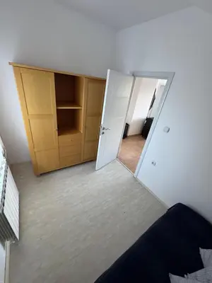 a mirror reflection of a bedroom with a door and a closet at Vlasina Nature Escape in Lujinska Mala