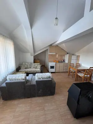 a living room with a couch and a table at Vlasina Nature Escape in Lujinska Mala