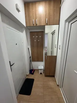 a hallway with wooden cabinets and a hallway with a door at Vlasina Nature Escape in Lujinska Mala