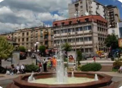 a large fountain in front of a large building at Janković in Vranje