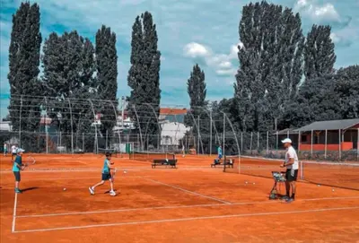 a group of people playing tennis on a tennis court at Janković in Vranje