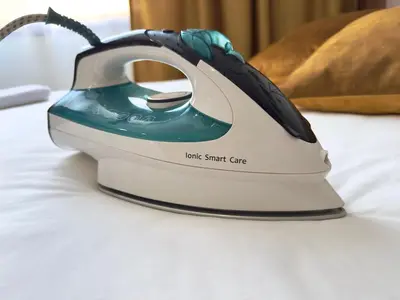 a iron sitting on top of a bed at Coco Kop studio in Kopaonik